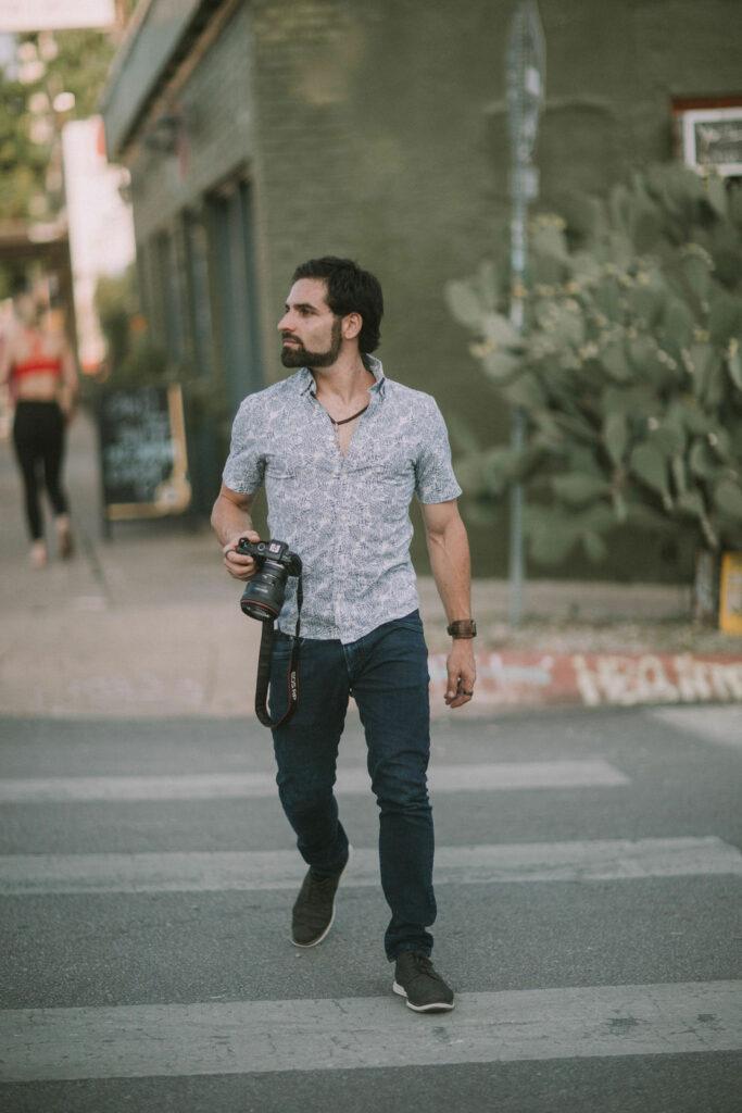 Dating profile photographer walking with camera to photoshoot